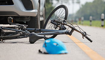 A bicycle resting on the roadside